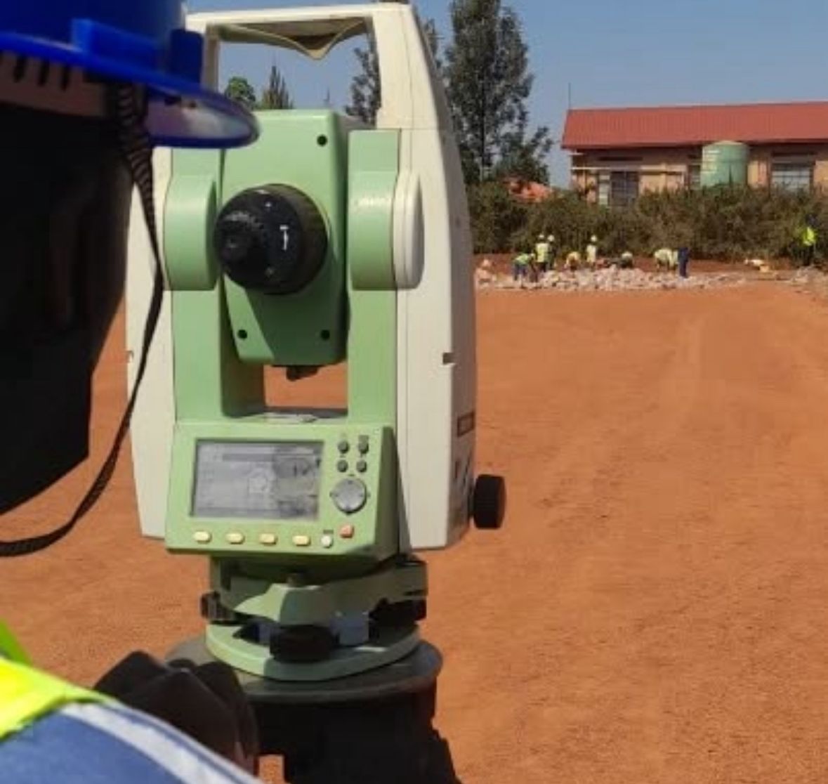 Surveyor with total station on site